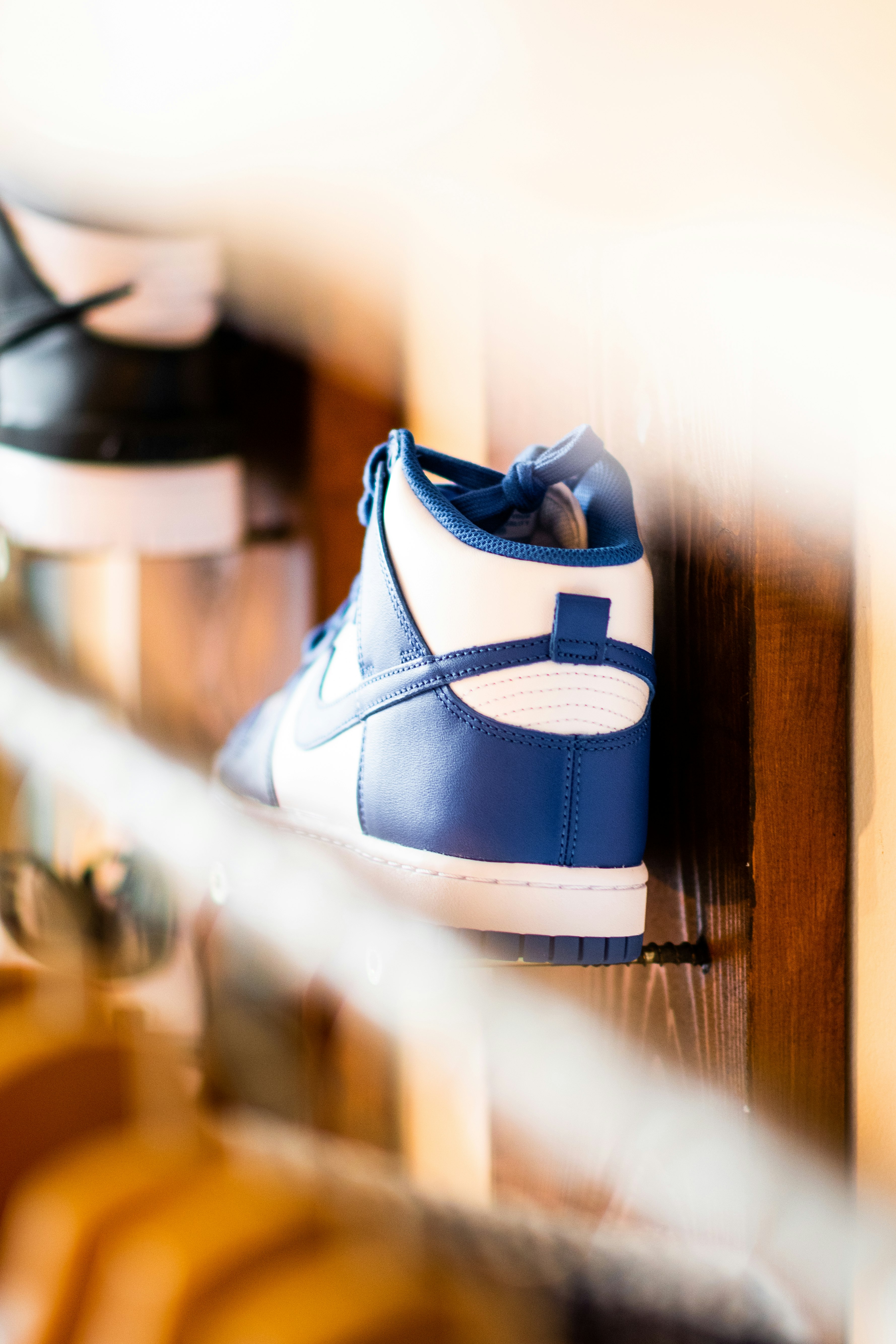 white and blue nike athletic shoe